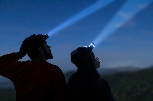 Free Photo man and woman with head lights