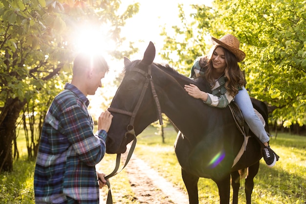 Man and woman with horse medium shot