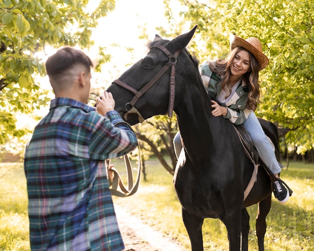 Free photo man and woman with horse