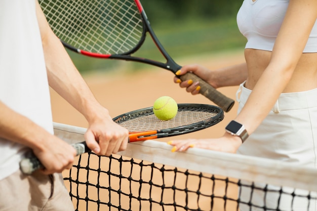 Man and woman with tennis rackets