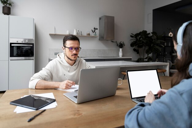 Man and woman working from home together at desk