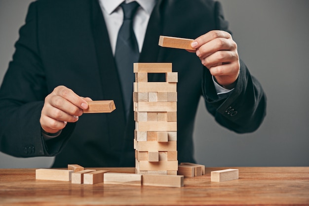 Free photo man and wooden cubes on table. management concept