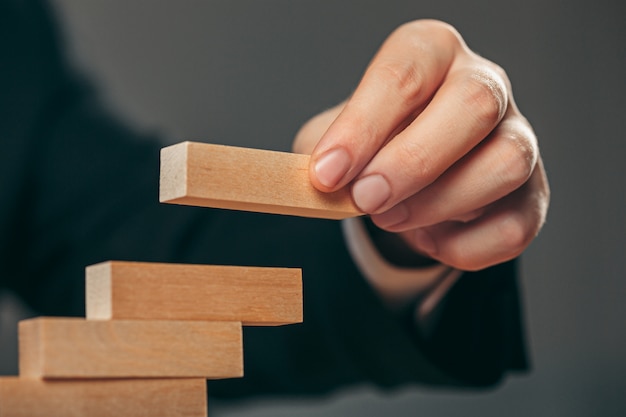 Man and wooden cubes on table. Management concept