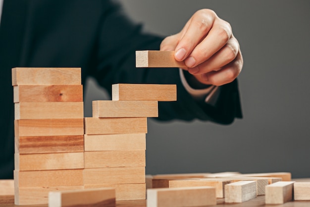 Free photo man and wooden cubes on table. management concept