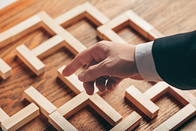 Free Photo man and wooden cubes on table. management concept