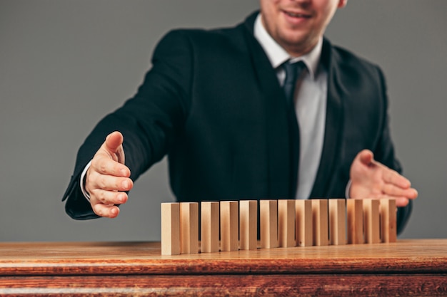 Free photo man and wooden cubes on table. management concept