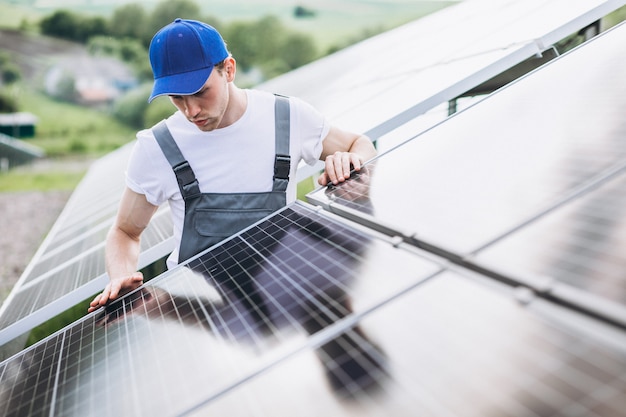 Free Photo man worker in the firld by the solar panels