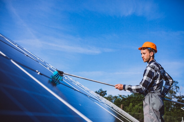 Free Photo man worker in the firld by the solar panels