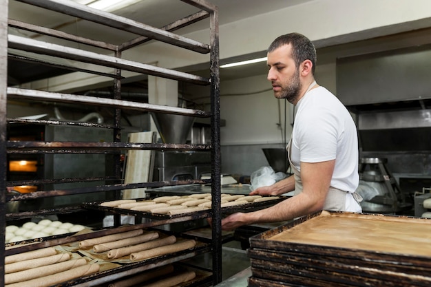 Free Photo man working in a bread bakery