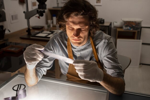 Man working in darkroom high angle