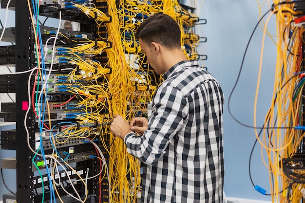 Free Photo man working on an ethernet switch