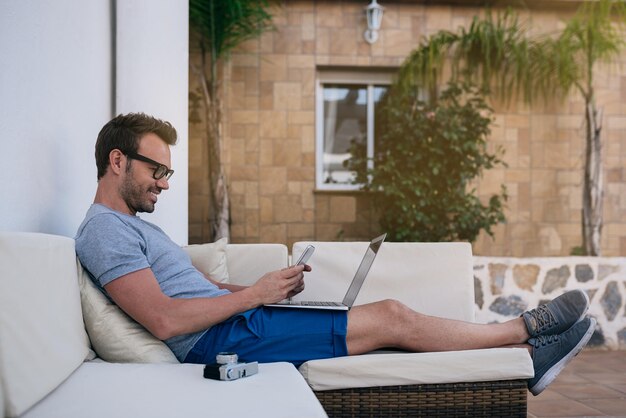 Man working from home at the yard on his computer