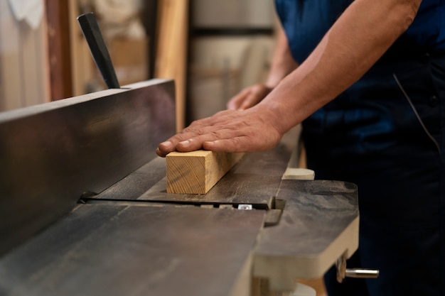 Man working in his wood shop with tools and equipment