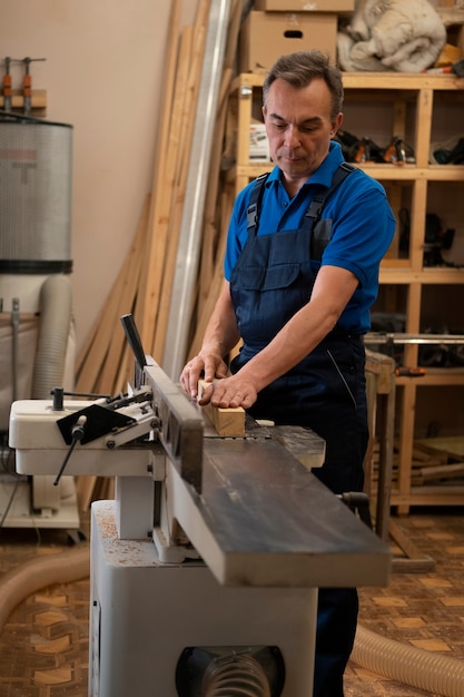 Man working in his wood shop with tools and equipment