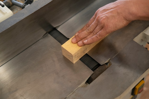 Free photo man working in his wood shop with tools and equipment