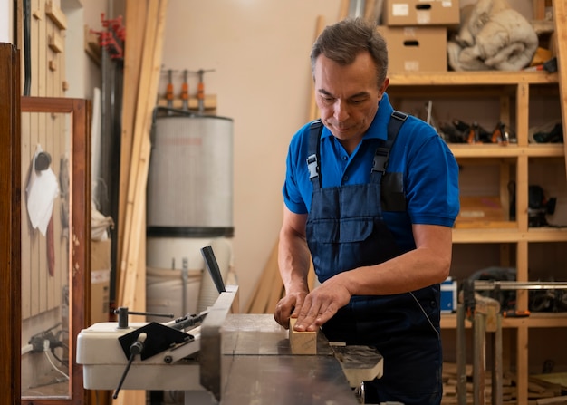 Man working in his wood shop with tools and equipment