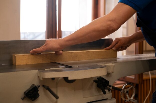 Man working in his wood shop with tools and equipment