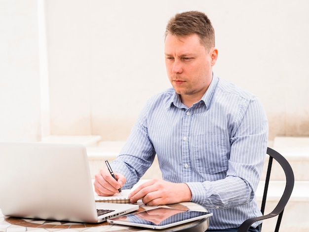 Man working on laptop outdoors