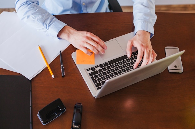 Man working on laptop sitting at table