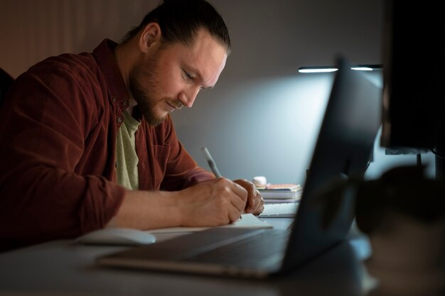 Man working late at night side view