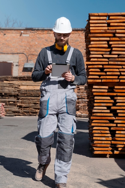 Free Photo man working in a mdf boards warehouse