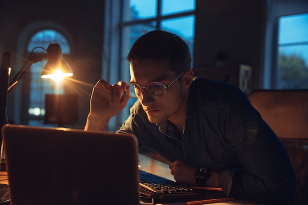 Free Photo man working in office alone