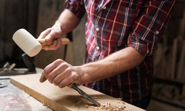 Free Photo man working with wood in workshop