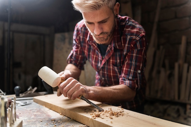 Free Photo man working with wood in workshop