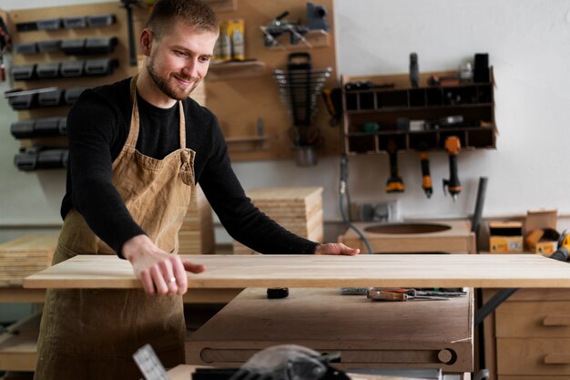 Free Photo man working in a wood engraving workshop