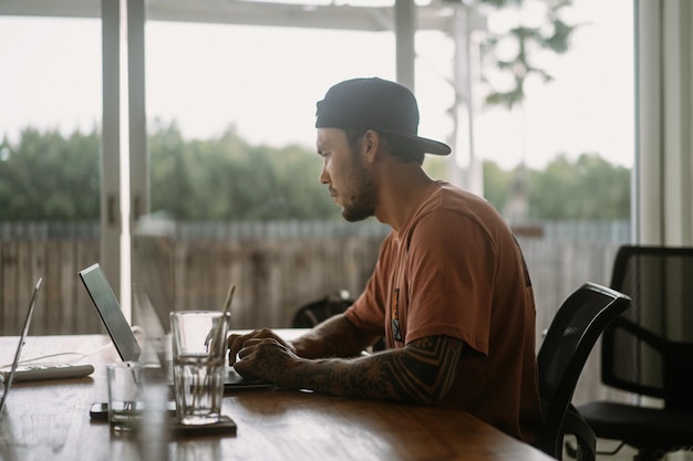 A man works at a computer in a coworking space. Remote work, workspace.