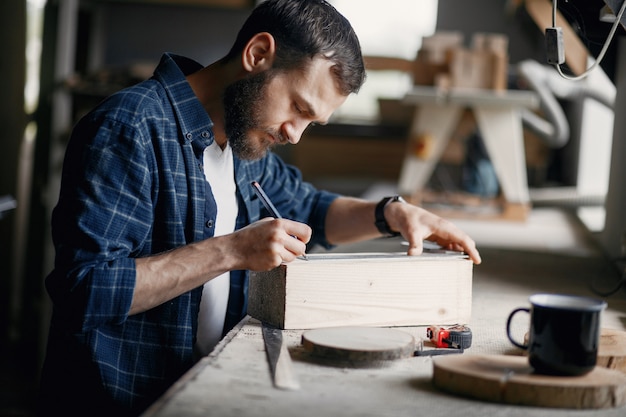 Free photo man in the workshop with a wood