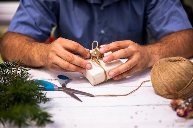 Free photo man wrapping a cute gift