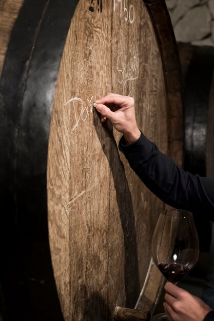 Man writing on barrel side view