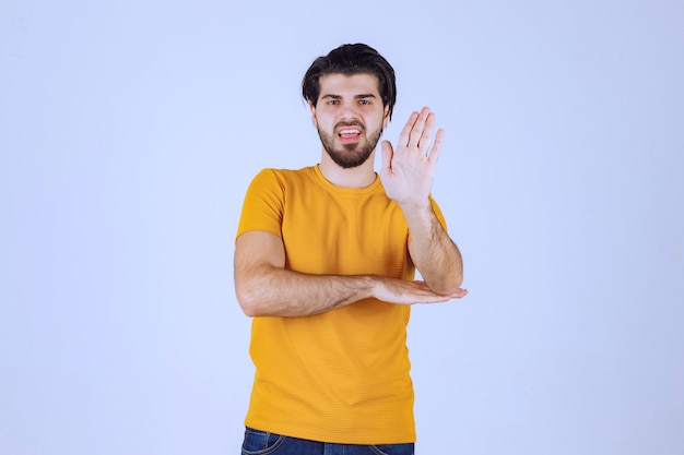 Man in yellow shirt stopping something