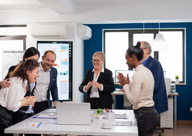 Management team clapping overjoyed in conference room after good training