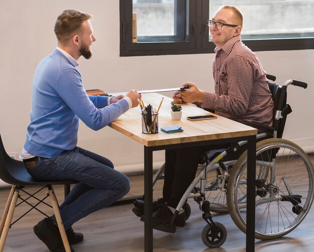 Manager working together with disabled worker