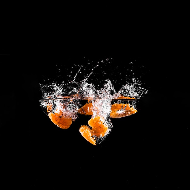 Free photo mandarine plunging into the water