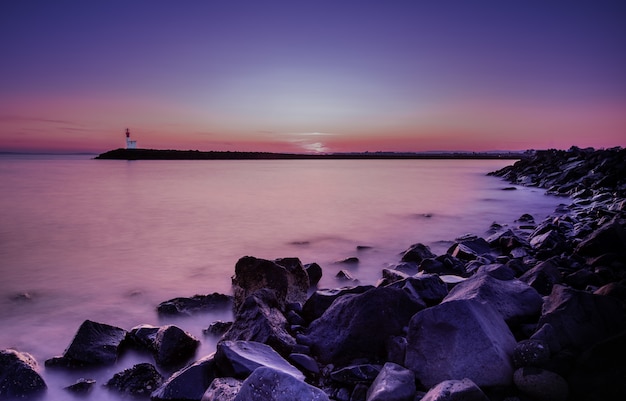 Free Photo mangnific sunset at a sea shore long shot