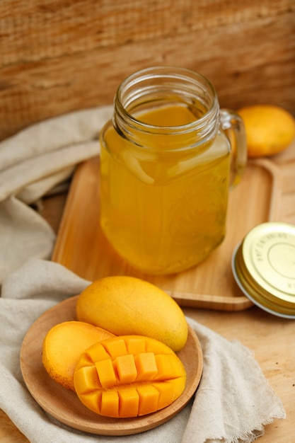 Free Photo mango juice in the glass on the wooden table