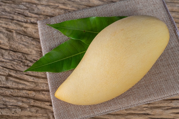 Free Photo mango placed on wooden floor.