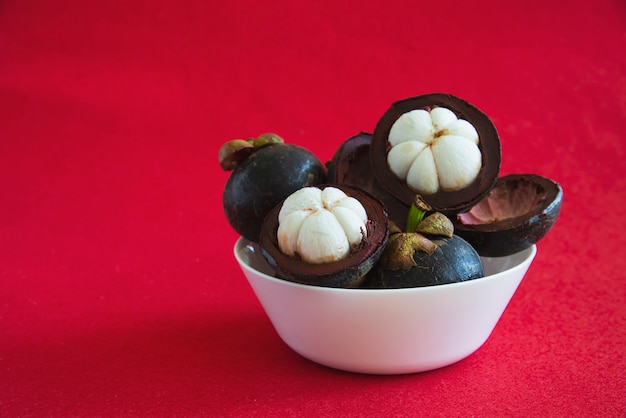 Mangosteen Thai popular fruits - a tropical fruit with sweet juicy white segments of flesh inside a thick reddish-brown rind.