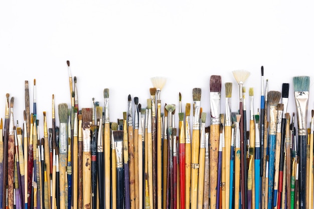 Many brushes for painting on a white background top view