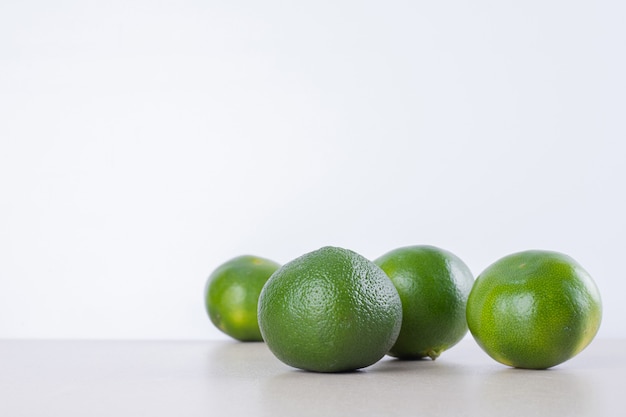 Free photo many of green tangerine on marble.