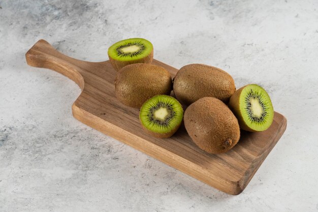 Many of kiwi fruits on wooden board. 