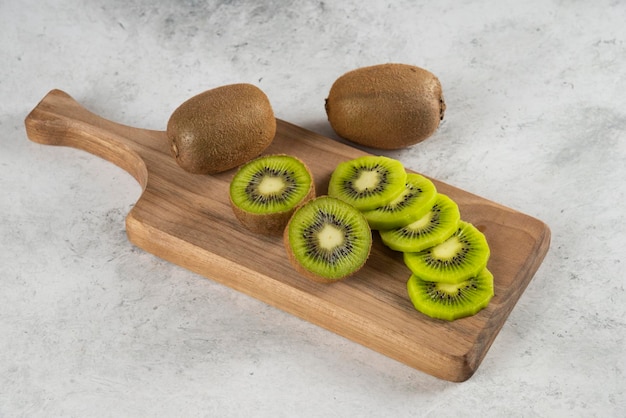 Many of kiwi fruits on wooden board. 