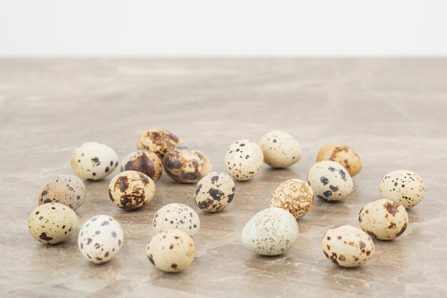 Many of quail eggs in the marble surface 