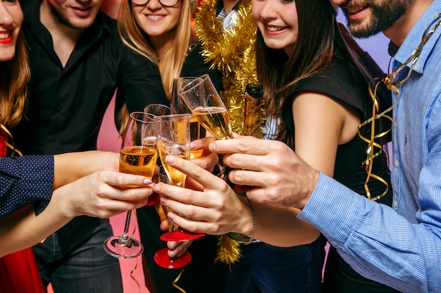 Many young women and men drinking at christmas party