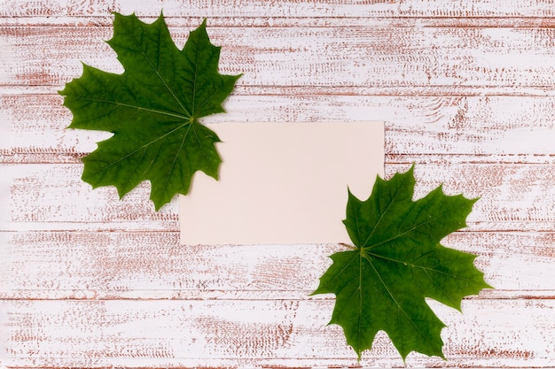 Free photo maple leaves mock-up on wooden desk