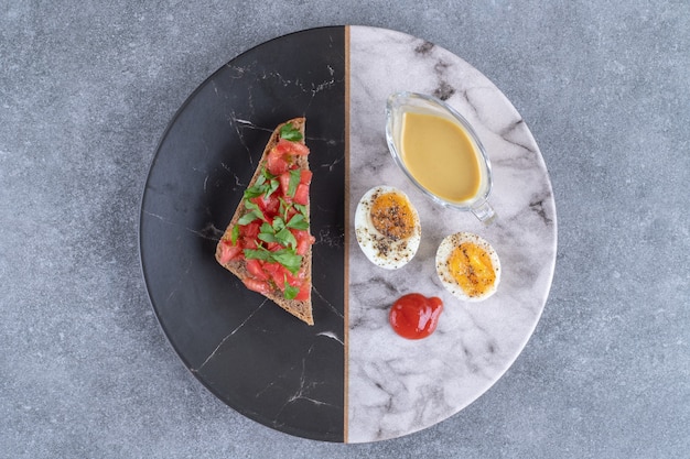 A marble plate with boiled egg and toast . High quality photo