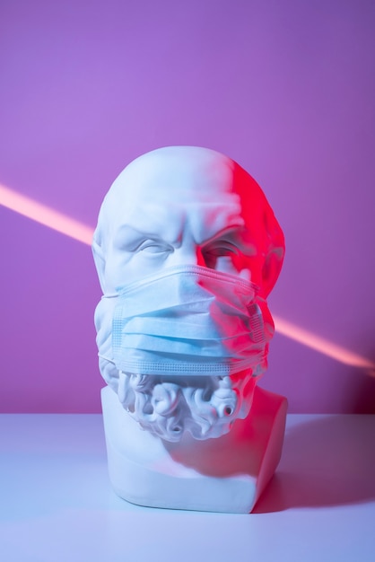 Free Photo marble sculpture of historical figure with medical mask